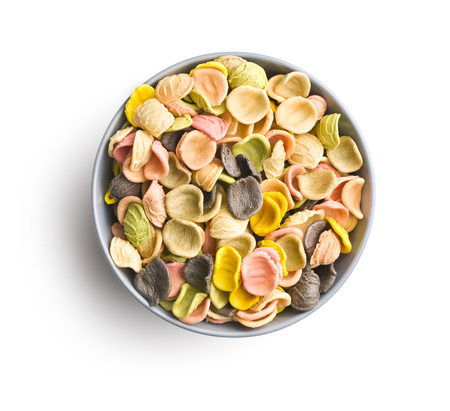 Italian rainbow pasta in bowl isolated on white background.の写真素材