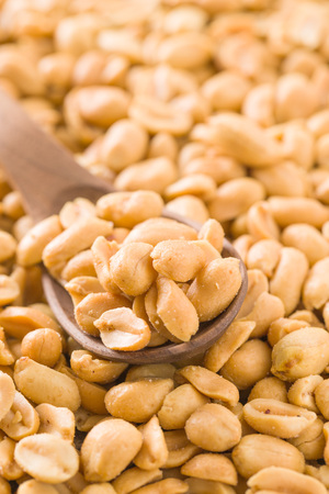 Salted roasted peanuts in scoop.の写真素材