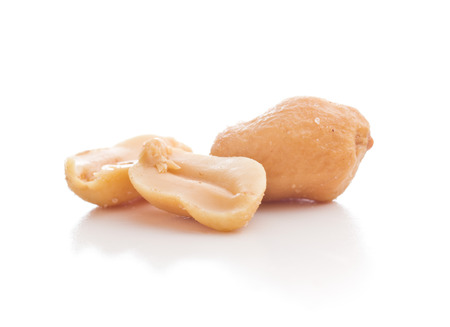 Salted roasted peanuts isolated on white background.