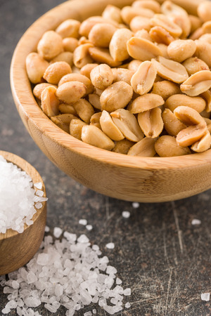 Salted roasted peanuts in bowl.の写真素材