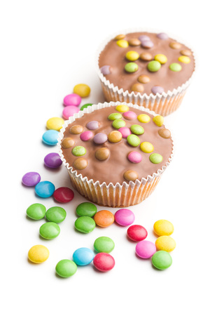 Sweet cupcakes with candies isolated on white background.の写真素材