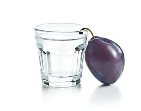 Plum brandy and plums. Tasty slivovitz isolated on white background.の写真素材