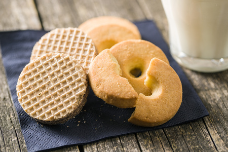 Sweet buttery biscuits on old wooden table.