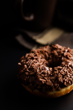 Sweet glazed donut with chocolate on black table.の写真素材