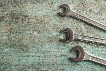Chrome vanadium wrench. Industrial spanner on old table.の写真素材