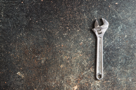 Chrome vanadium wrench. Industrial spanner on old table.の写真素材