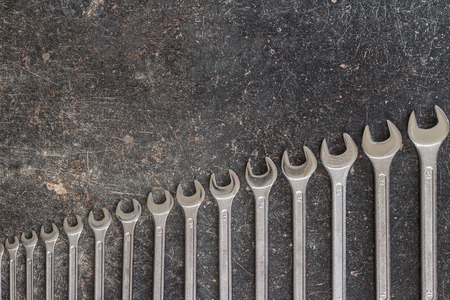 Chrome vanadium wrench. Industrial spanner on old table.の写真素材