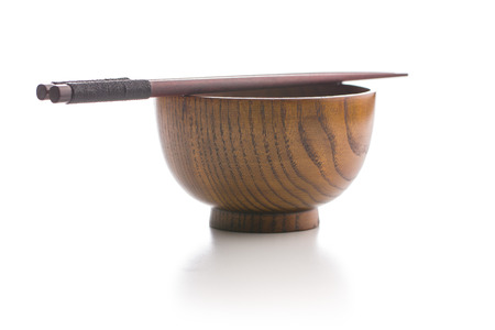 Wooden bowl and chopsticks isolated on whiteの写真素材