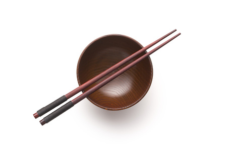 Wooden bowl and chopsticks isolated on white background.の写真素材