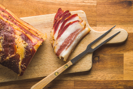 Sliced smoked bacon on cutting board. Top view.の写真素材