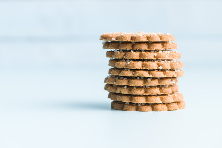 Christmas biscuits with sugar crystals on blue table.の写真素材