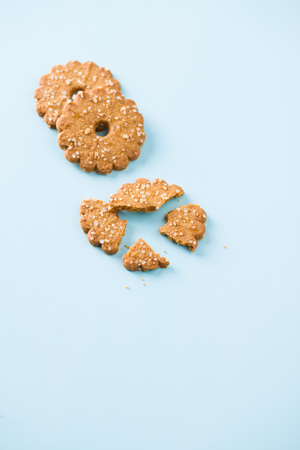 Christmas biscuits with sugar crystals on blue table.の写真素材
