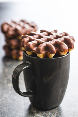 Waffles with chocolate topping and mug.の写真素材