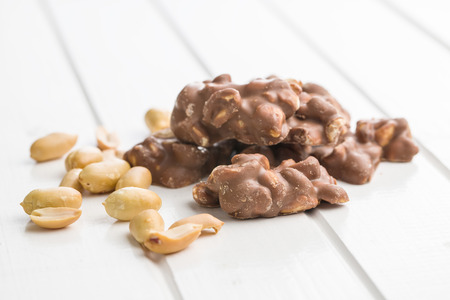 Peanuts covered chocolate. Tasty sweet chocolate truffles.