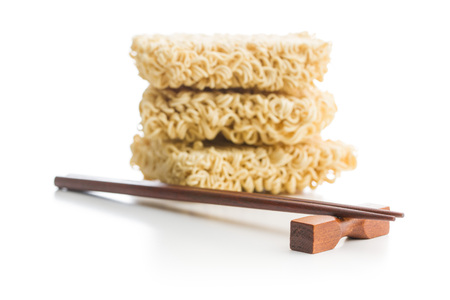 Wooden chopsticks and instant noodles isolated on white background.の写真素材