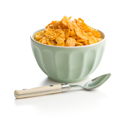 Breakfast cereals or cornflakes in bowl and spoon isolated on white background.