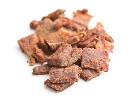 Beef jerky pieces isolated on white background. Marinated dried meat.の写真素材