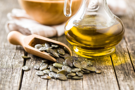Peeled pumpkin seeds and oil.の写真素材