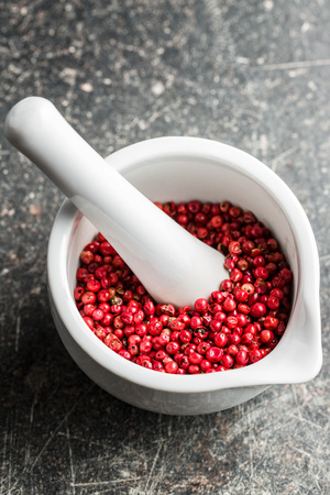 Dried pink peppercorn in  mortar.の写真素材