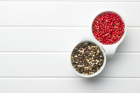 Different types of dried peppercorn in bowl.の写真素材