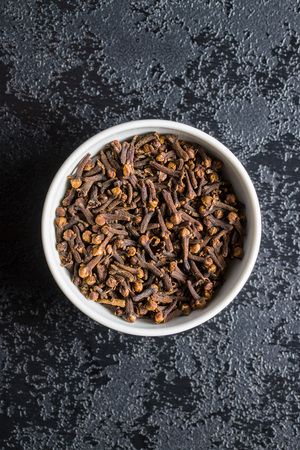 Carnation, dried clove spice in bowl.の写真素材