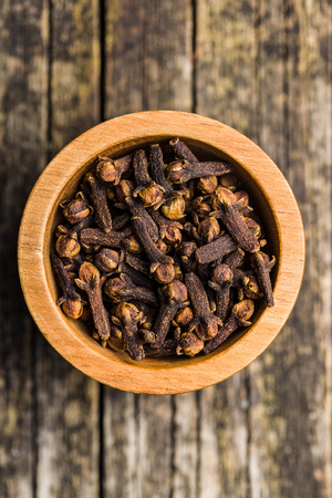 Carnation, dried clove spice in bowl.の写真素材