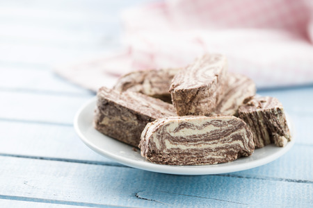 Sweet halva dessert slices with cocoa on plate.