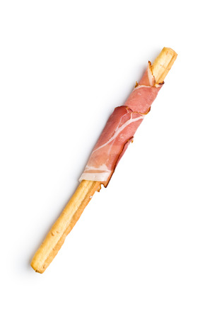 Parma ham prosciutto with grissini breadsticks isolated on white background.の写真素材