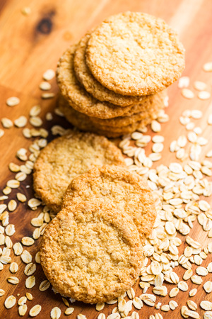 Crispy oatmeal cookies on wooden table.の写真素材