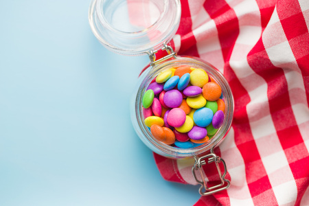 Colorful chocolate candy pills in jar.の写真素材