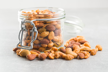 Spicy flavoured nuts. Mix of nuts in jar.の写真素材