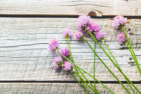 Chives with Flowers on old wooden table.