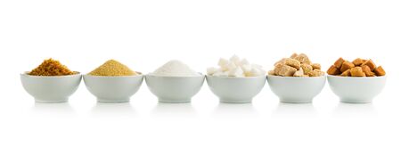 Brown and white sugar in bowls isolated on white background.の写真素材