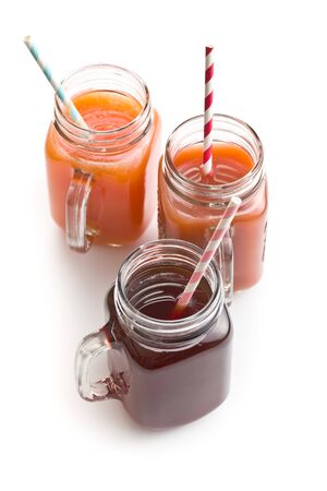 Glass of fruity juice with straw isolated on white background.の写真素材