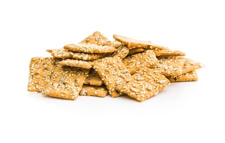 Salted crispy crackers with sesame and sunflower seeds isolated on white background.の写真素材
