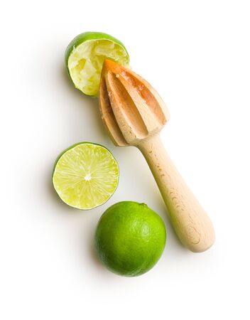 Wooden citrus squeezer and green lime isolated on white table.の写真素材