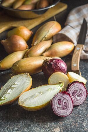 Halved fresh bulbs on old kitchen table.の写真素材