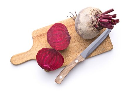 Tasty raw beetroot. Sliced beetroot on cutting board isolated on white background.