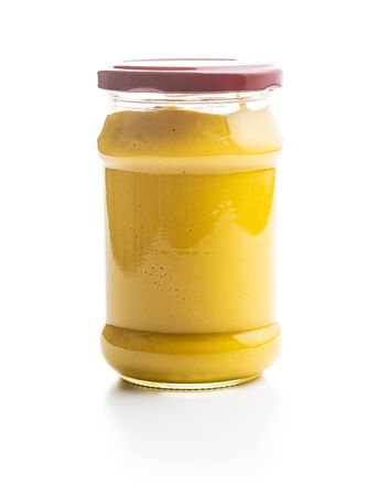 Yellow mustard in jar isolated on white background.の写真素材
