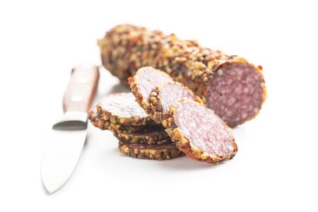 Spicy salami sausage and knife isolated on white background.の写真素材