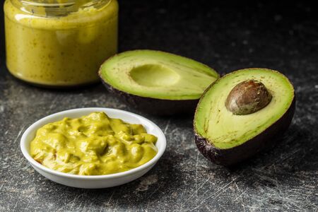 Avocado dip. Guacamole sauce on kitchen table.