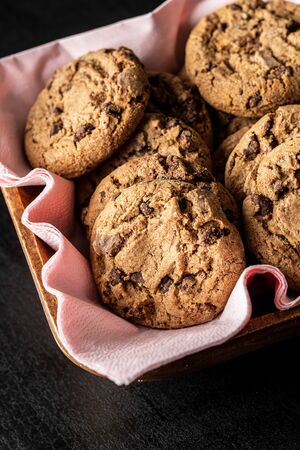 Sweet chocolate cookies in wooden bowl.