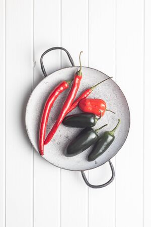 Hot jalapeno, habanero and chili peppers on white table. Top view.の写真素材