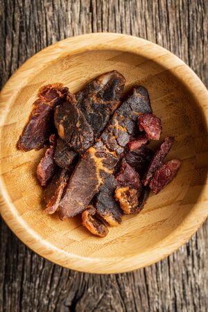 Beef jerky pieces. Dried beef meat in bowl. Top view.の写真素材