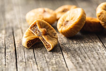 Sweet dried figs on old wooden table.の写真素材