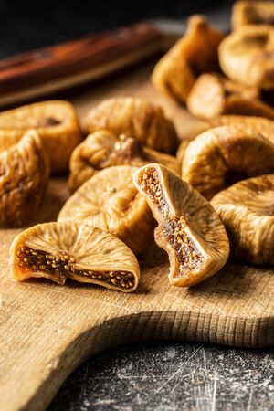 Sweet dried figs on cutting board.の写真素材