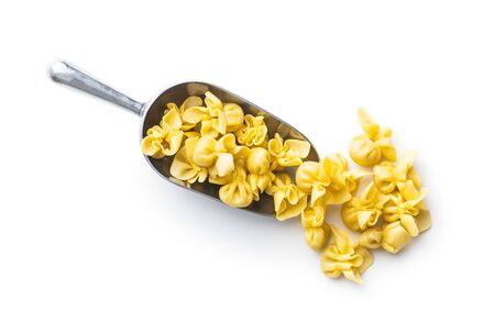 Italian stuffed pasta in scoop. Sacchettini pasta isolated on white background.の写真素材