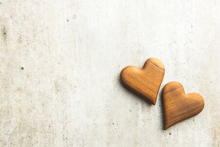 Two wooden hearts on vintage background. Love concept.