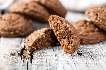 Cereal cocoa cookies on old wooden table.の写真素材