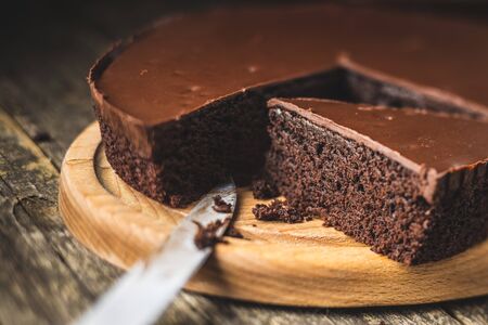 Chocolate brownies cake on wooden cutting board.